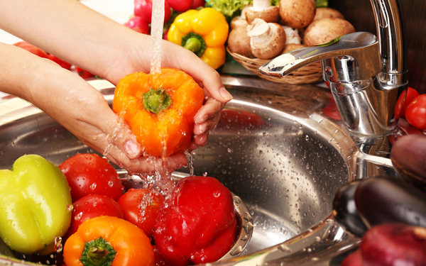 キッチンで野菜を洗う女性の手